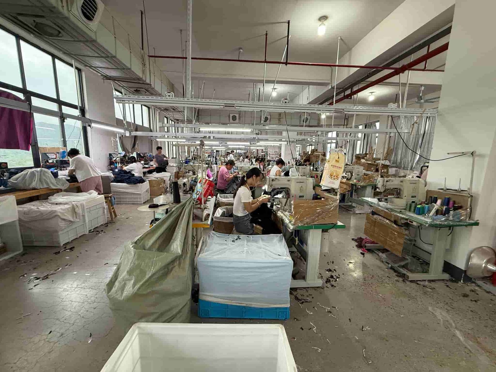 MOVEVOX activewear production floor with OEM garment samples at the Yiwu manufacturing base