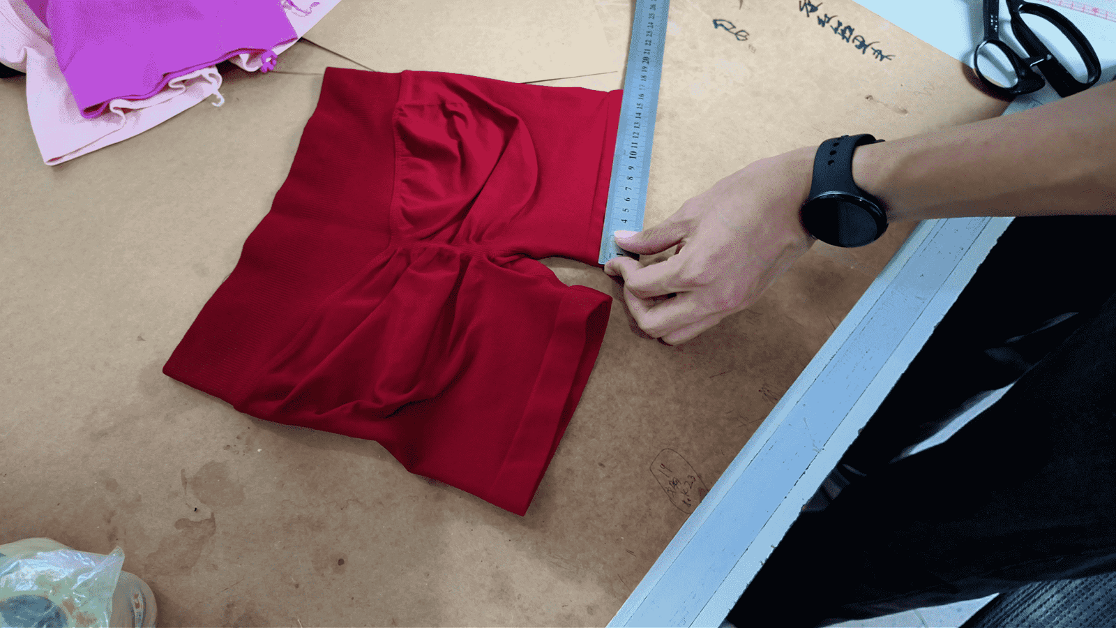 MOVEVOX QC staff measuring activewear during garment quality inspection