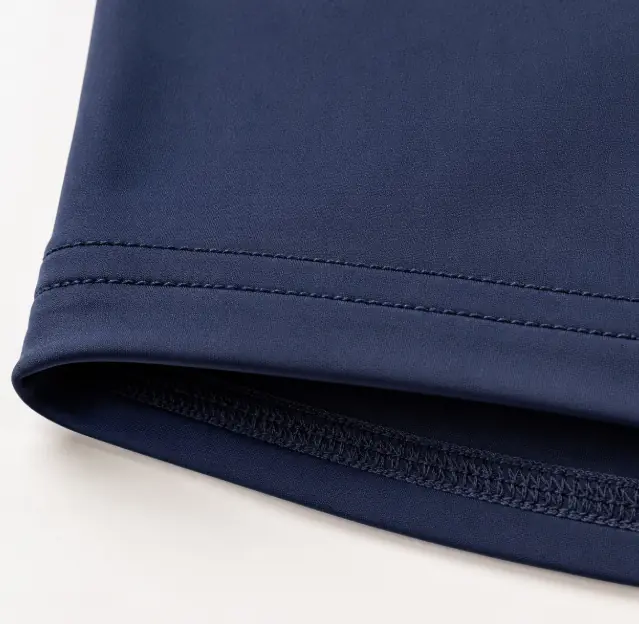 Close-up of overlock seam and enclosed knit fabric edges on a sewn sportswear sample