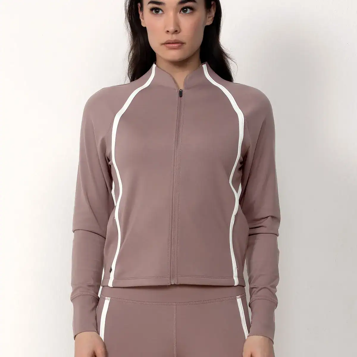Lightweight zip-up athleisure jacket with tailored stretch panels and zippered pockets