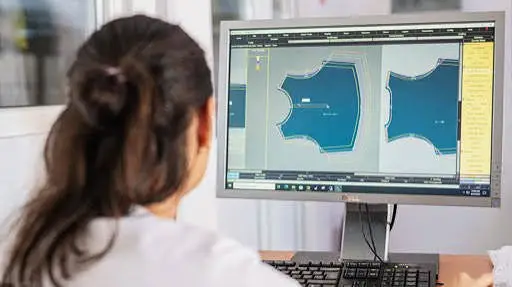 Fashion designer sketching custom athletic leggings and sports bra concepts