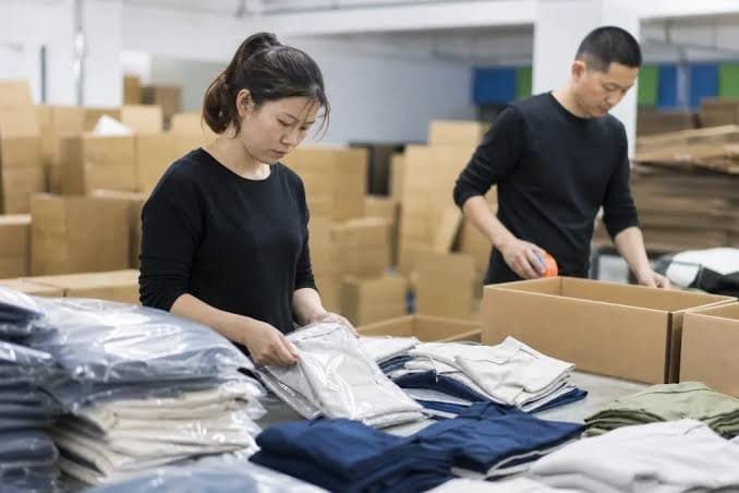 Sportswear garments being checked for labels barcodes polybags and carton packing