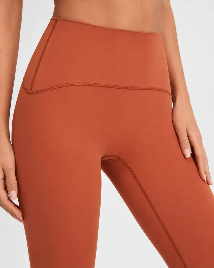 Close-up of four-needle six-thread flatlock seam construction on multi-panel athletic leggings