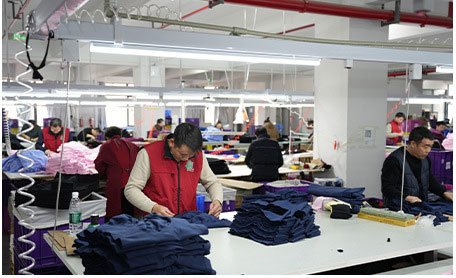 MOVEVOX cut-and-sew production floor with sewing equipment and activewear garments