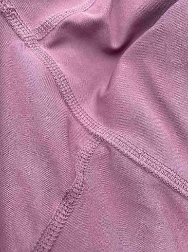 Close-up of MOVEVOX flatlock seam on performance activewear