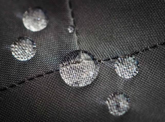 Water repellent droplets beading on DWR coated stretch woven activewear shorts