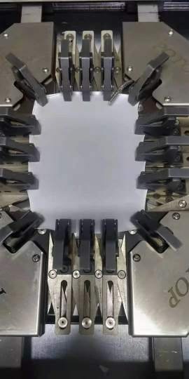 Biaxial mechanical stretch clamp apparatus holding activewear sample at 40 percent elongation