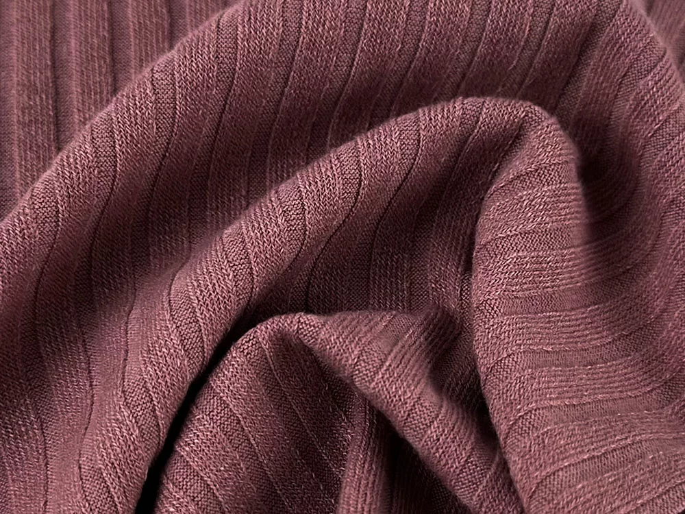 Zoned rib and drop needle knit structure for stretch activewear