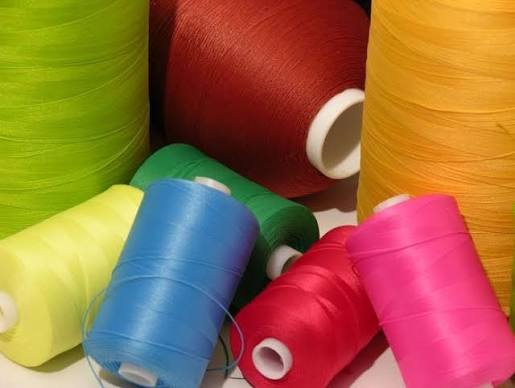 High elongation woolly nylon looper thread spool for athletic activewear seams