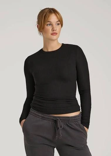 Longline yoga long sleeve top illustrating extended body coverage and hip-level hem positioning