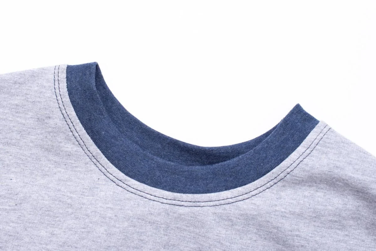 Close-up of neckline binding on a seamless knitted performance T-shirt