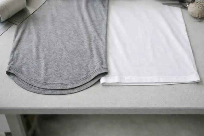 Topside close-up of visible coverstitch lines on a stretch long sleeve hem