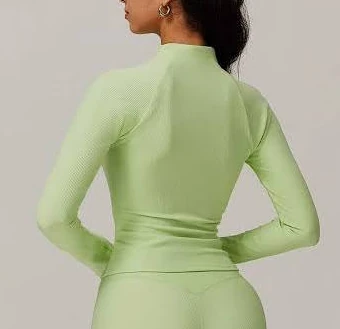 Close-fitting seamless long-sleeve base layer showing neckline, sleeves and body silhouette