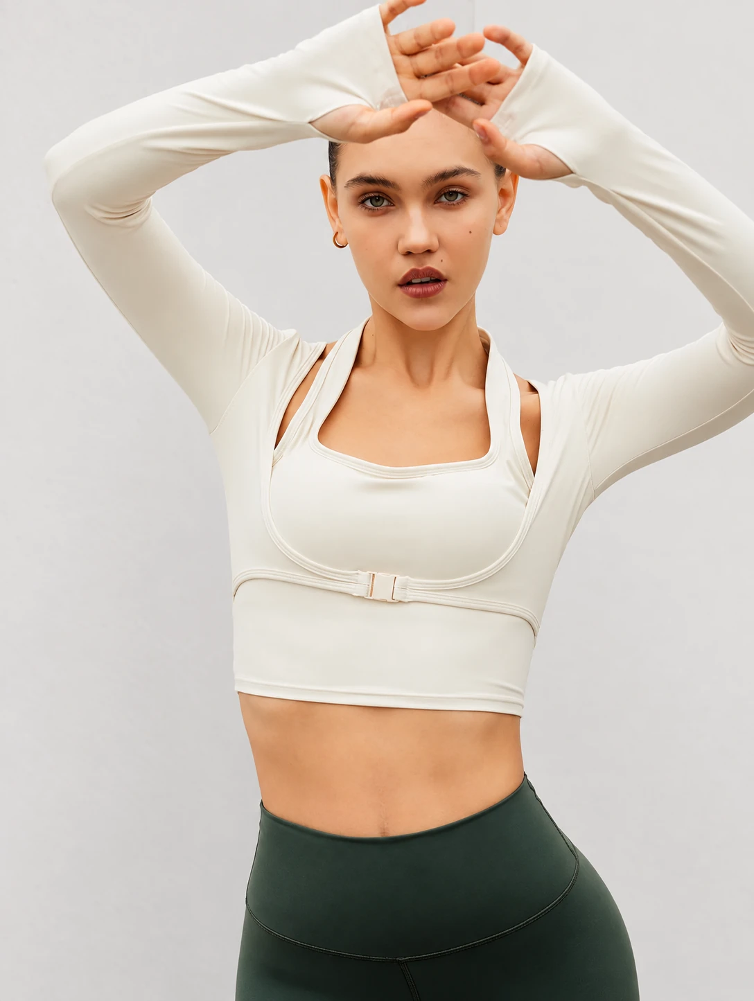 Front and back seamless long-sleeve construction reference identifying the torso, shoulder, sleeve, elbow, wrist and thumbhole areas