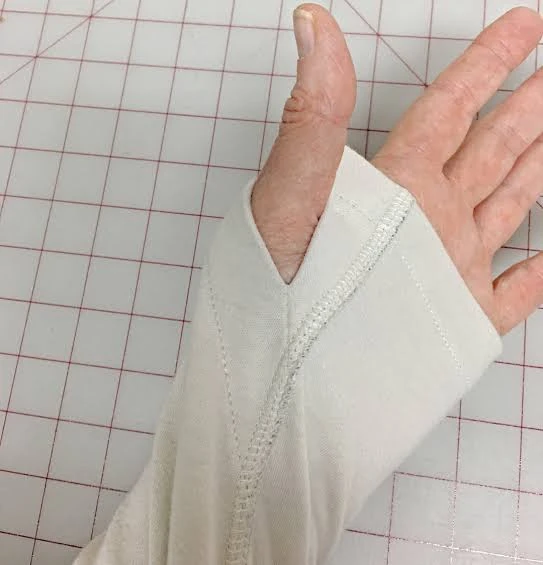 Long-sleeve seamless workout top showing thumbhole cuff details