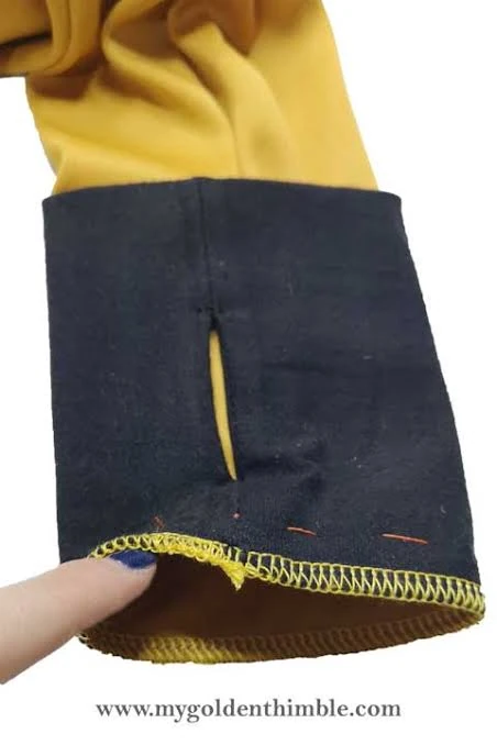 Detailed stitching and edge reinforcement around a long sleeve thumbhole opening
