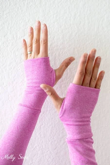Paired long sleeve thumbhole cuffs showing left and right opening positions and symmetry