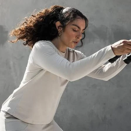 Long sleeve gym training top used during upper-body exercise