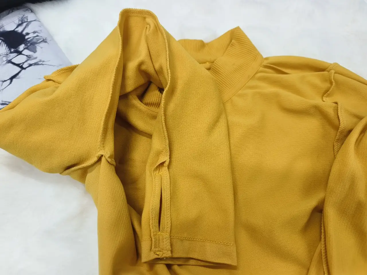 Inner-arm knitted surface detail of a close-fitting seamless long sleeve