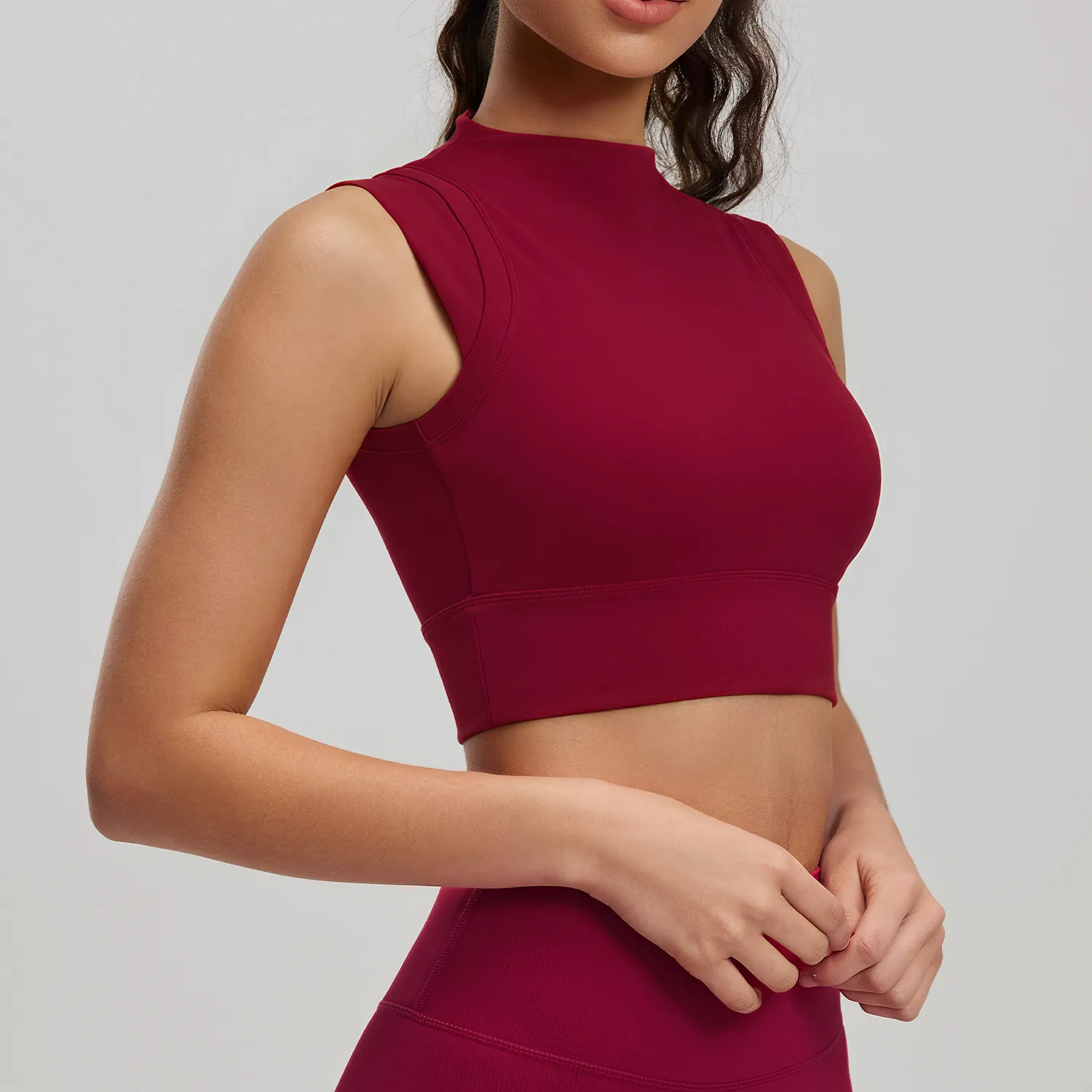 High-neck seamless tank with full front neckline coverage and shaped shoulders