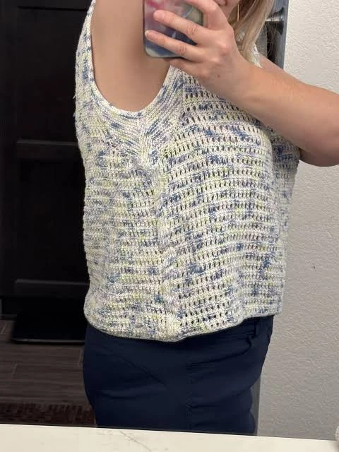 Seamless tank armhole edge close-up showing adjoining open and dense knitted structures
