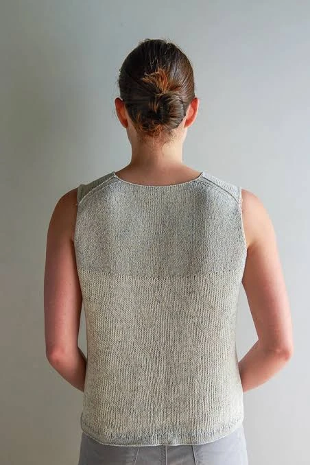 Lower torso knit texture on a seamless tank showing a structural transition toward the hem
