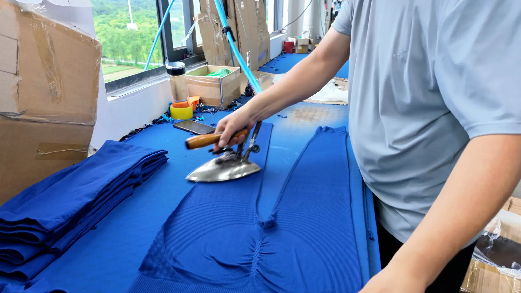 MOVEVOX garment steam pressing and finishing work area with actual production equipment