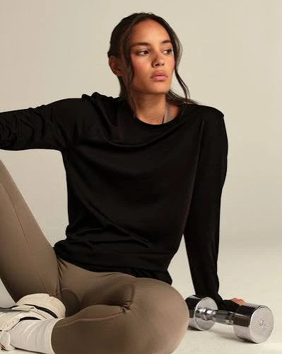 Cropped sleeveless gym top showing armhole design and short hem position