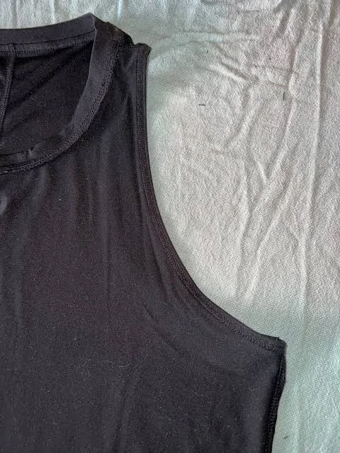 Close-up of fabric binding around a gym tank armhole opening