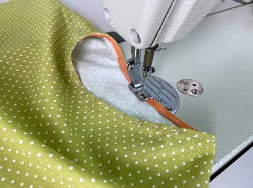 Close-up of overlock seam joining stretch knit fabric panels in conventional activewear construction