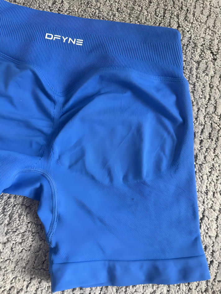 Front and back compression shorts technical sample showing waistband rise crotch thigh and leg opening construction