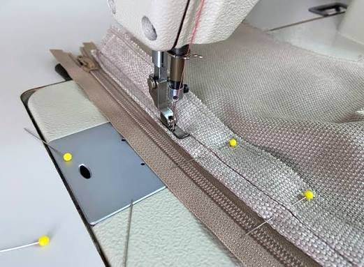 Half zip opening end close up showing the bottom stop and inside reinforcement