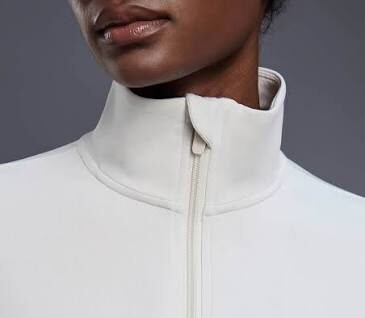 Stand collar and half zip chin guard inside construction at the collar junction